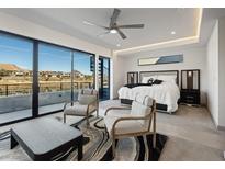 Bright bedroom with stylish decor, ceiling fan, and sliding glass doors to a patio at 36 Lakefront Dr, Henderson, NV 89011