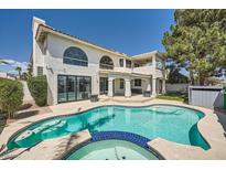 A stunning view of the custom pool and spa with a covered patio in the background at 4504 Dunlap Crossing St, Las Vegas, NV 89129