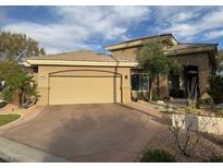 Single-story home featuring desert landscaping and a two car garage at 512 Pima Canyon Ct, Las Vegas, NV 89144