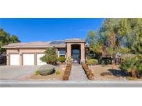 Stunning single-story home features a tile roof, desert landscaping, and an iron gate entrance at 5193 N Miller Ln, Las Vegas, NV 89149