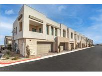 Modern townhome community with brick accents and attached garages at 600 N Carriage Hill Dr # 2098, Las Vegas, NV 89138