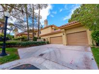Inviting home featuring a spacious driveway, three-car garage, and manicured landscaping at 7969 Bermuda Dunes Ave, Las Vegas, NV 89113