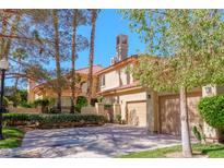 Inviting two-story home with a two-car garage, mature trees, and well-manicured landscaping at 7969 Bermuda Dunes Ave, Las Vegas, NV 89113