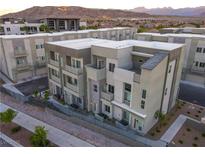 Modern townhome exterior featuring clean lines, neutral tones, and private balconies with mountain views at 1163 Blossom Point St, Las Vegas, NV 89135