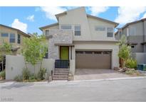 Stunning two-story home with modern design, stone accents, and a well-manicured front yard in a residential neighborhood at 12123 Glentana View St, Las Vegas, NV 89138