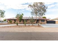 Charming single-story home boasting a tile roof, desert landscaping, and solar panels at 1500 Tumbleweed Dr, Henderson, NV 89002
