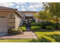 Charming single-story home with a well-manicured lawn and lovely landscaping at 240 Jumping Springs Pl, Henderson, NV 89012