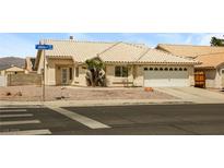 Charming single-story home featuring a xeriscaped yard, tile roof, and attached two-car garage at 3214 W Gilmore Ave, North Las Vegas, NV 89032