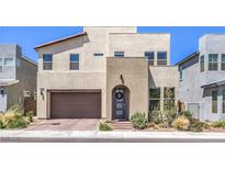 Contemporary two-story home featuring desert landscaping, a two-car garage, and a welcoming front entry at 3216 Monte Luna Ave, Henderson, NV 89044