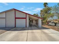 Charming single-story home featuring a covered front entrance and a spacious driveway leading to an attached garage at 7055 Sylvan Oak Dr, Las Vegas, NV 89147