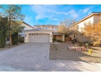 Beautiful two-story home featuring a front yard, a two-car garage, and a brick driveway at 10993 Ladyburn Ct, Las Vegas, NV 89141