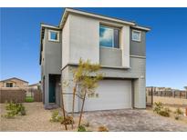 Two-story home featuring neutral paint, a two-car garage, and low-maintenance landscaping in a residential neighborhood at 11800 Black Canary Ave, Las Vegas, NV 89138