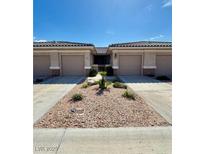 Charming single-story home featuring desert landscaping, a covered entry, and attached two-car garages at 3263 Quail Song Dr, Laughlin, NV 89029
