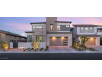 Modern two-story home with stone accents, a two-car garage, and manicured landscaping at 484 Windstone Crest Ave, Las Vegas, NV 89138