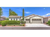 Charming single-story home featuring desert landscaping and a spacious three-car garage at 5260 Acqua Ln, Pahrump, NV 89061