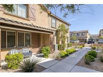 Attractive two-story home boasts stylish shutters and a well-manicured front yard with a seating area at 6247 Milford Sound St, Las Vegas, NV 89148