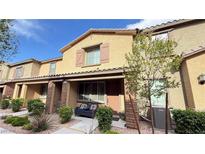 Charming two-story townhome with covered porch and cozy front patio seating area at 6247 Milford Sound St, Las Vegas, NV 89148