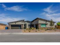 Beautiful single-story home featuring a modern design, desert landscaping, and a two-car garage at 8310 W Camero Ave, Las Vegas, NV 89113