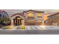 Inviting two-story home featuring a three-car garage and elegant architectural details at 885 Violet Hill St, Las Vegas, NV 89110