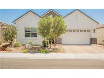 Charming home with a two-car garage, desert landscaping, and attractive architectural details at 8968 Skye Treeline St, Las Vegas, NV 89166