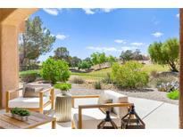 Relaxing patio area with outdoor seating and a view of the lush green landscape at 10557 Shoalhaven Dr, Las Vegas, NV 89134