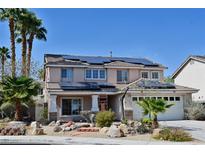 Charming two-story home with solar panels, a two-car garage, and desert landscaping at 1105 Enderly Ln, Las Vegas, NV 89144