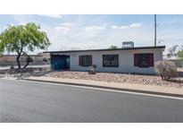 Charming single-story home featuring gray siding, red shutters, and low-maintenance gravel landscaping at 170 Copper St, Henderson, NV 89015