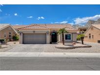 Charming single-story home with a tile roof, desert landscaping, and an attached two-car garage at 2305 Hot Oak Ridge St, Las Vegas, NV 89134