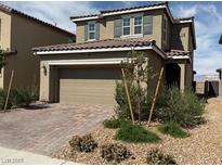 Charming two-story home featuring a two-car garage and a well-maintained, low-water, desert landscaped front yard at 2321 Teatro Ave, Henderson, NV 89044
