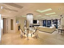 Elegant living room featuring a modern fireplace and a luxurious chandelier above the glass dining table at 2747 Paradise Rd # 1703, Las Vegas, NV 89109