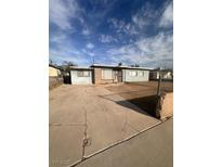 Single story home with a driveway and desert landscaping under a cloudy blue sky at 2820 Fort Sumter Dr, North Las Vegas, NV 89030