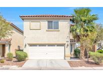 Two-story home featuring a two-car garage, stucco siding, and a red tile roof at 3314 Villa Fiori Ave, Las Vegas, NV 89141