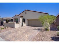 Charming single-story home featuring a two-car garage, desert landscaping, and a private gated courtyard at 390 Inflection St, Henderson, NV 89011