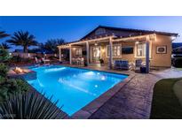 Stunning backyard pool with a covered patio and a fire pit, perfect for outdoor entertaining at 5852 Ireland Ridge Ct, Las Vegas, NV 89149