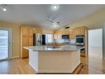 Bright kitchen features stainless appliances, granite countertops, and a central island at 6582 Cartgate Ct, Las Vegas, NV 89110