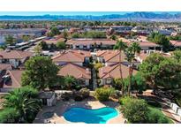 Aerial view of the neighborhood pool and hot tub surrounded by well-maintained landscaping and homes at 6733 W Charleston Blvd # 3, Las Vegas, NV 89146