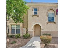 Inviting two-story townhome with desert landscaping and a cozy front entrance in a warm, neutral palette at 10550 W Alexander Rd # 2179, Las Vegas, NV 89129