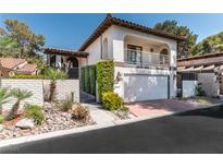 Two-story home featuring a tile roof, balcony, and a well-maintained front yard with mature landscaping at 2017 Plaza De Cielo, Las Vegas, NV 89102