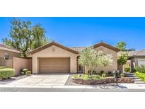 Charming single-story home featuring a well-maintained front yard and a two-car garage at 35 Glade Water Dr, Henderson, NV 89052