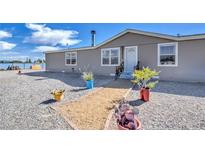 Charming single-story home with low-maintenance landscaping and a welcoming front entrance at 3611 W Horn Rd, Pahrump, NV 89048