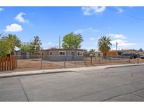 Single story home with a chain link fence and a gray exterior at 5867 Bunch St, Las Vegas, NV 89122