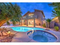 Inviting backyard oasis featuring a private pool, spa, and covered patio ideal for outdoor entertaining at 8204 Antler Pines Ct, Las Vegas, NV 89149