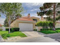 Charming two-story home with a red tile roof, attached two-car garage, and manicured landscaping in a suburban neighborhood at 8221 Crow Valley Ln, Las Vegas, NV 89113