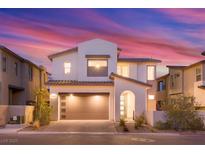 Charming two-story home featuring a modern design, a two-car garage, and desert landscaping at 828 Parker Mesa St, Las Vegas, NV 89138