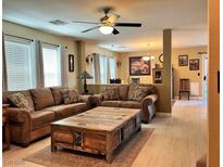 Inviting living room with tile floors, comfortable seating, and an eye-catching wooden coffee table at 1121 Majestic Canyon St, Henderson, NV 89052