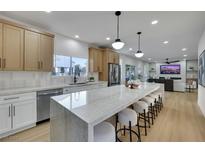 Modern kitchen with stainless steel appliances, marble countertops, and a large island with seating at 193 Jeri Dr, Henderson, NV 89074