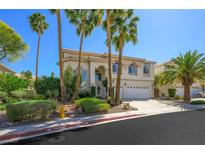 Beautiful two-story home with a well-maintained front yard and tall palm trees, creating a welcoming curb appeal at 2097 Eaglepath Cir, Henderson, NV 89074