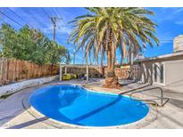 Backyard pool with a palm tree and shaded patio area at 2129 N Michael Way, Las Vegas, NV 89108
