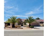 Charming single-story home featuring a tile roof, desert landscaping, and a two-car garage at 2349 Orangeburg Pl, Henderson, NV 89044