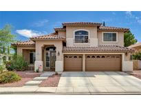 Inviting two-story home featuring a tile roof, three-car garage, and manicured landscaping at 3055 Whispering Crest Dr, Henderson, NV 89052